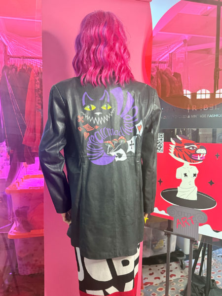 spark and rebel features upcycled leather jacket alice in wonderland in eco fashion